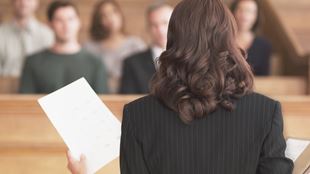 back of woman speaking to group